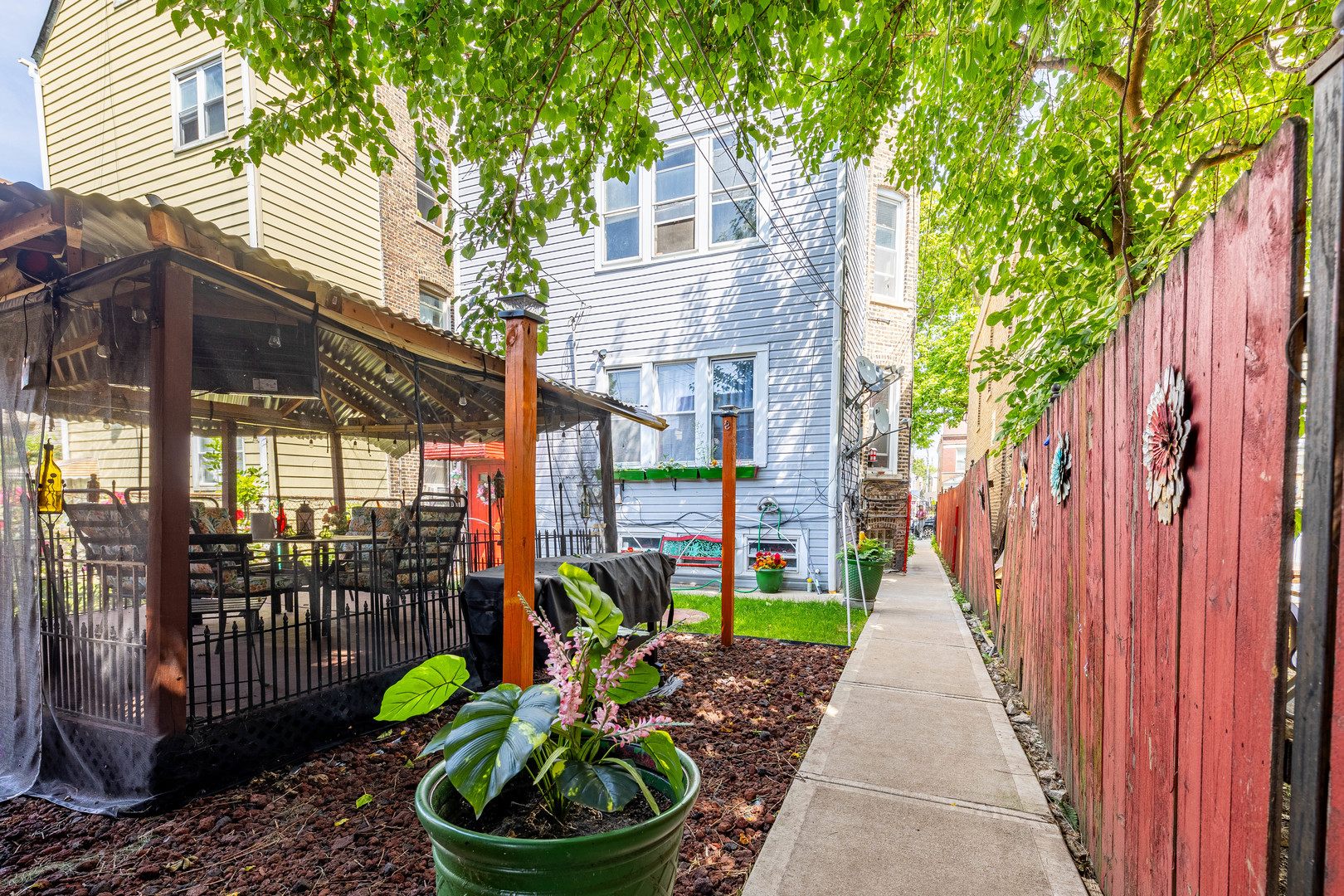 2434 South Harding Avenue Chicago, IL 60623 - Photo 21 of 21 a view of a chairs and table in backyard of the house