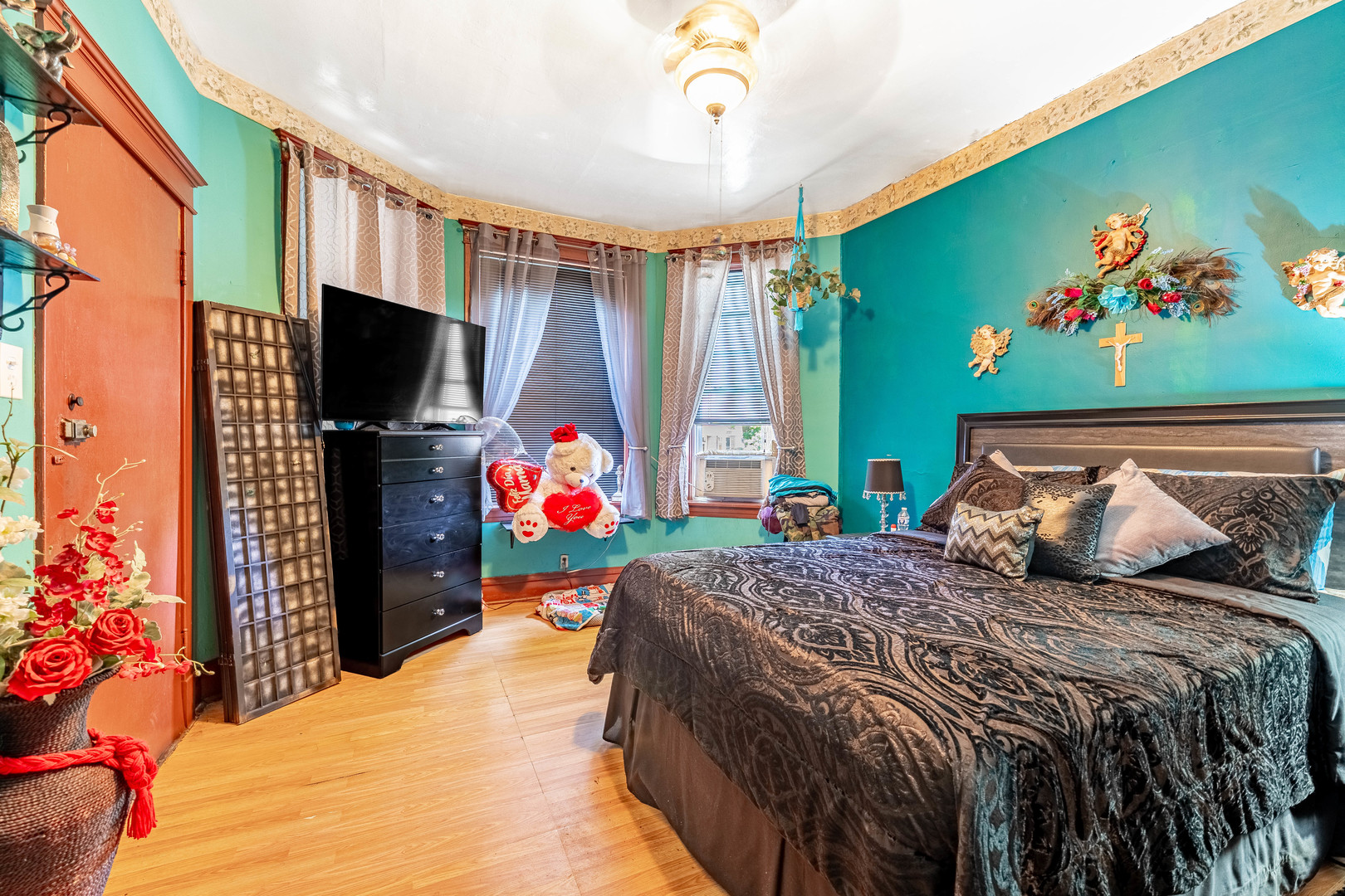 2434 South Harding Avenue Chicago, IL 60623 - Photo 4 of 21 a bedroom with a bed and a flat screen tv