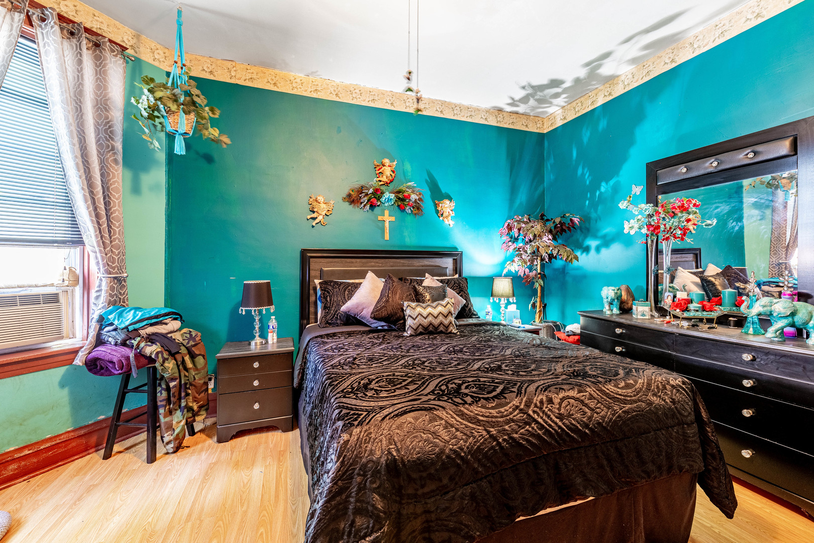 2434 South Harding Avenue Chicago, IL 60623 - Photo 5 of 21 a bedroom with a bed table flowerpot and window