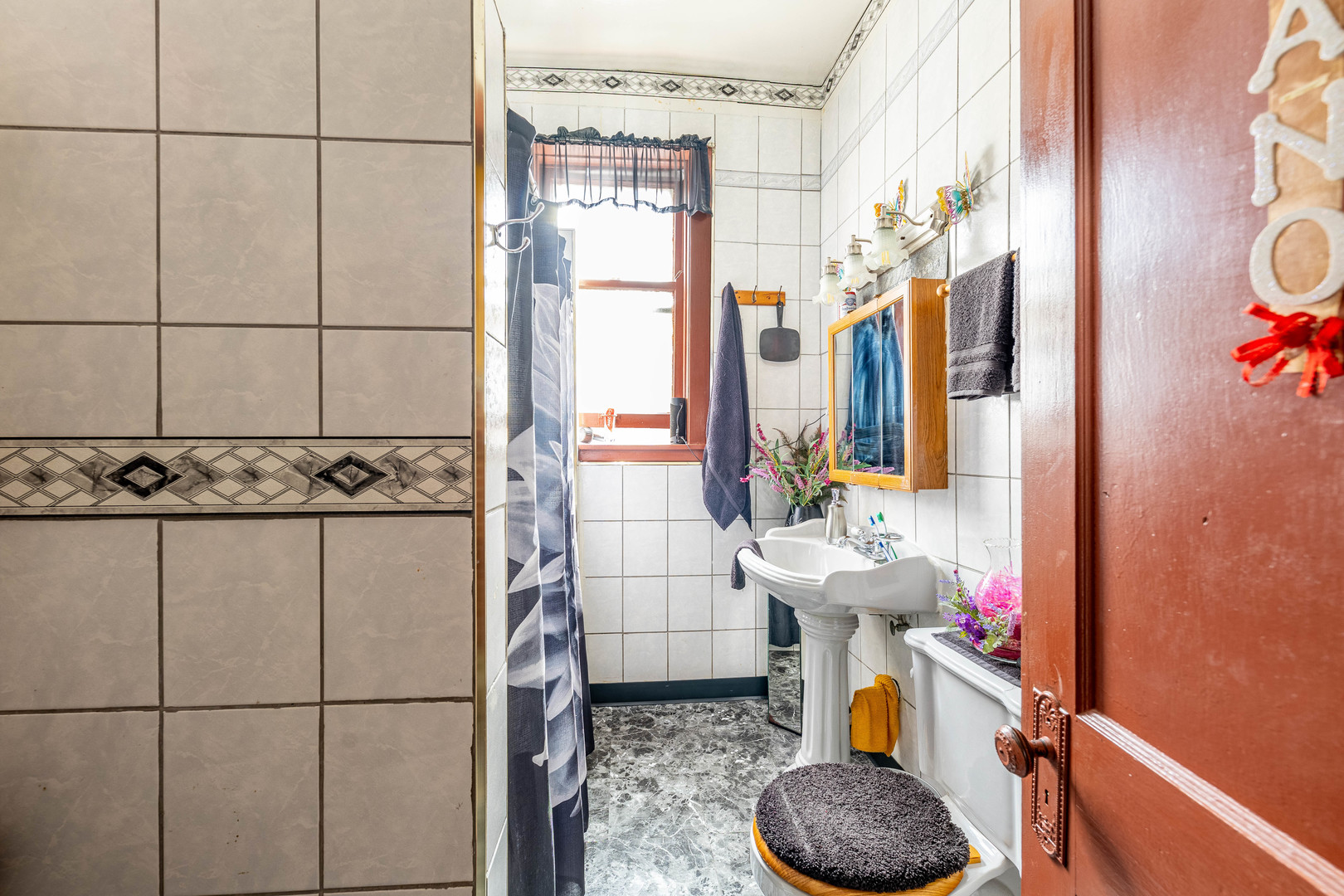 2434 South Harding Avenue Chicago, IL 60623 - Photo 7 of 21 a bathroom with a sink and a mirror