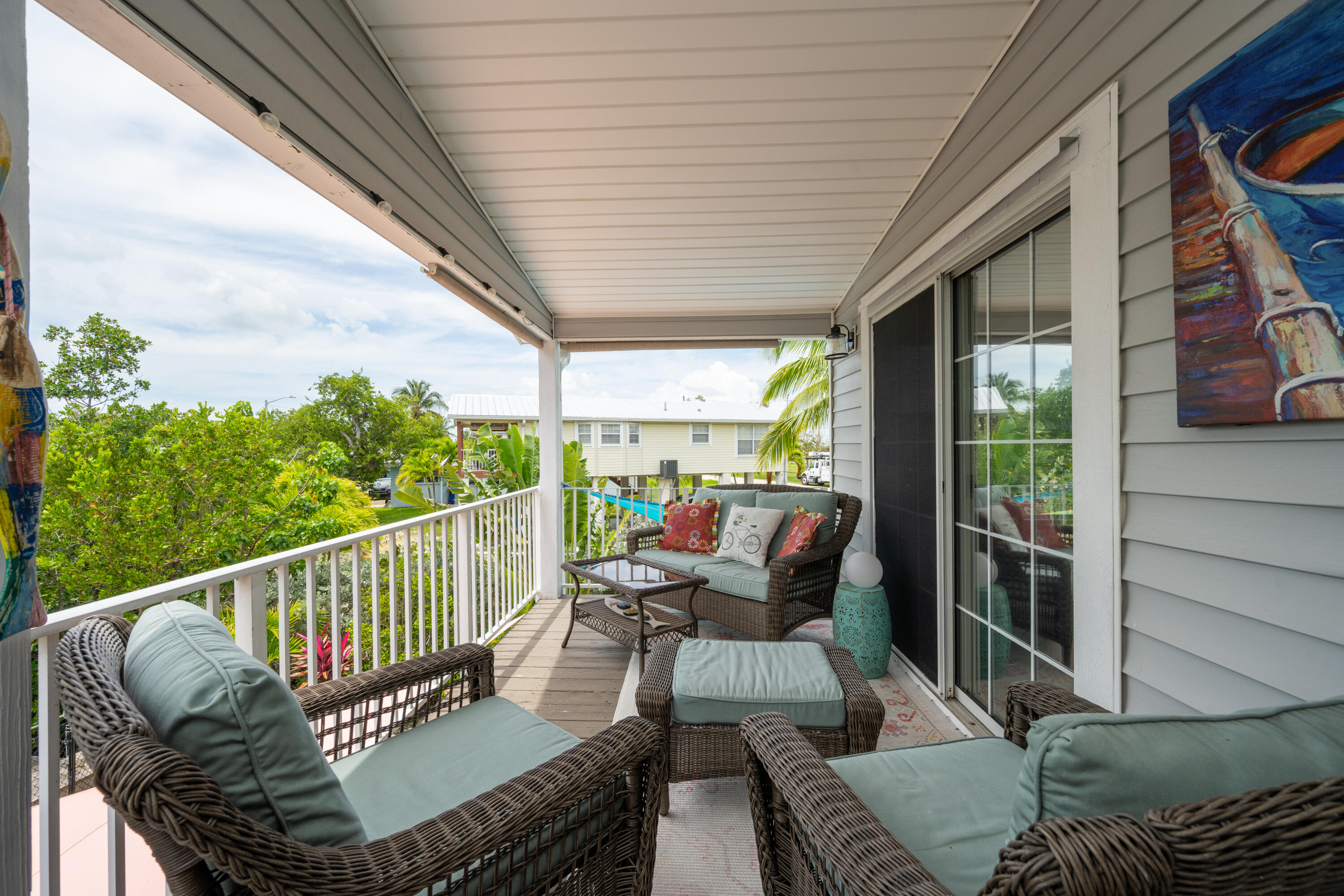 18 West Circle Drive Key West, FL 33040 - Photo 11 of 30 a balcony with wooden floor and outdoor seating
