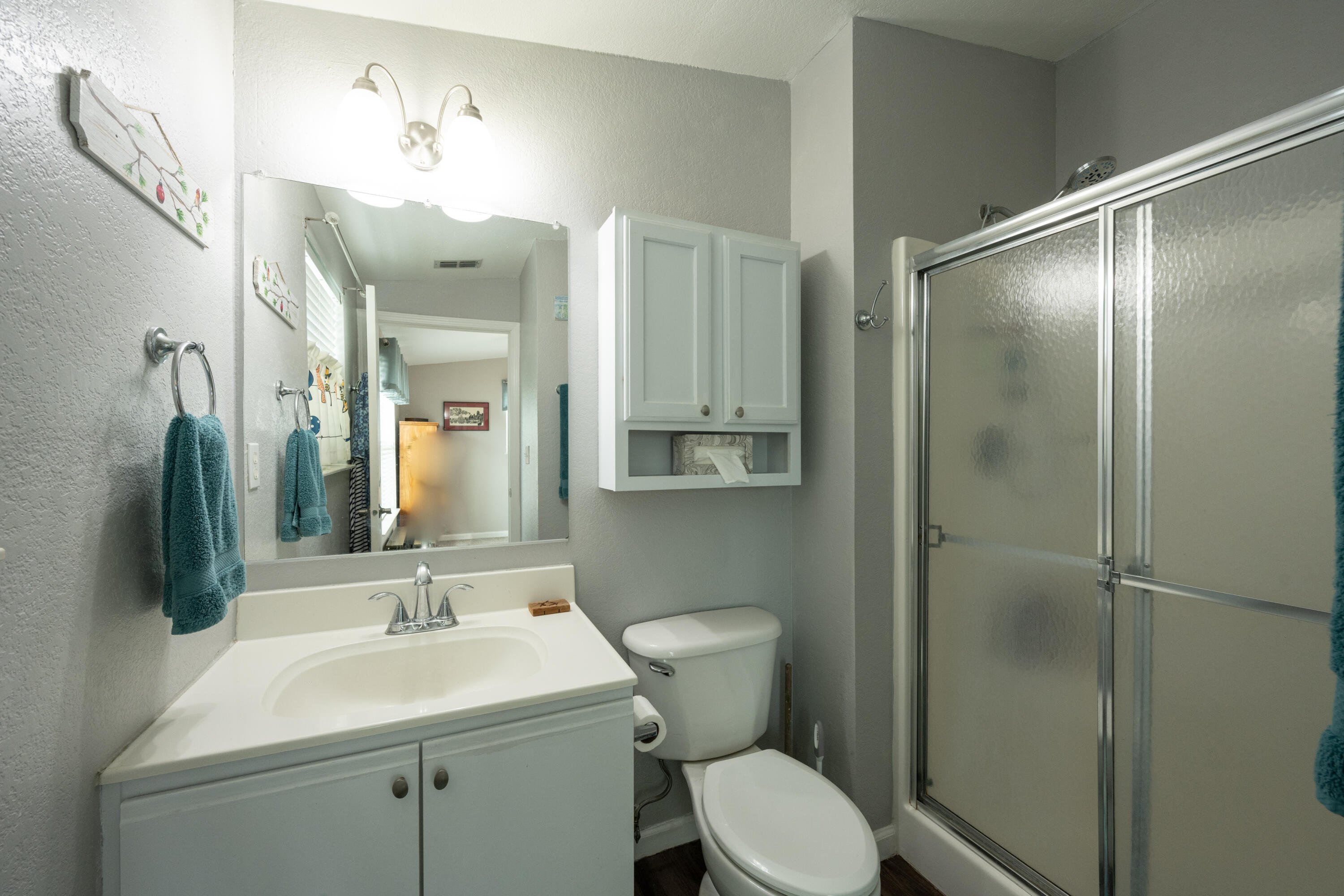 18 West Circle Drive Key West, FL 33040 - Photo 21 of 30 a bathroom with a toilet a sink a mirror and vanity