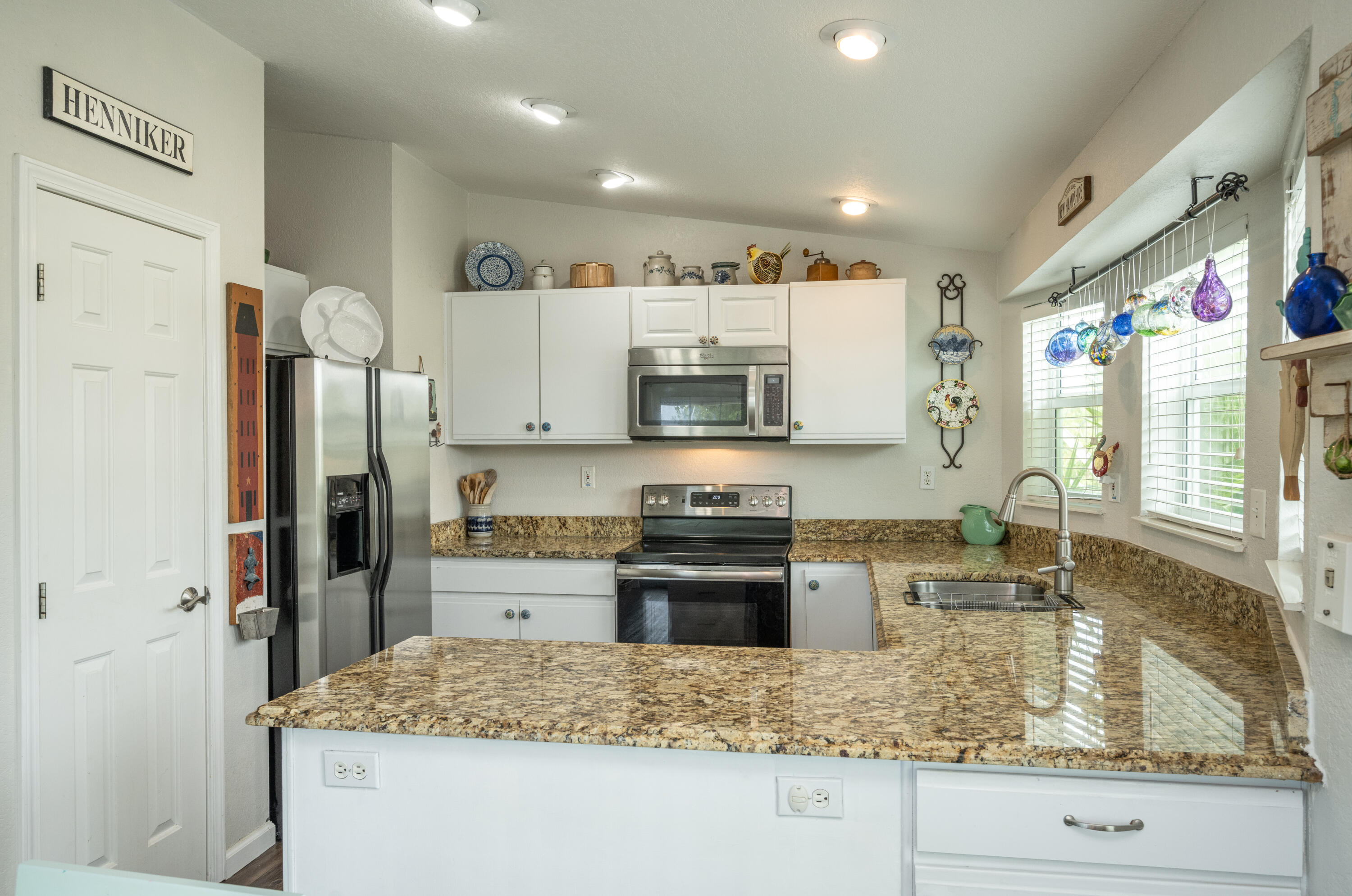 18 West Circle Drive Key West, FL 33040 - Photo 8 of 30 a kitchen with stainless steel appliances granite countertop a sink stove and refrigerator
