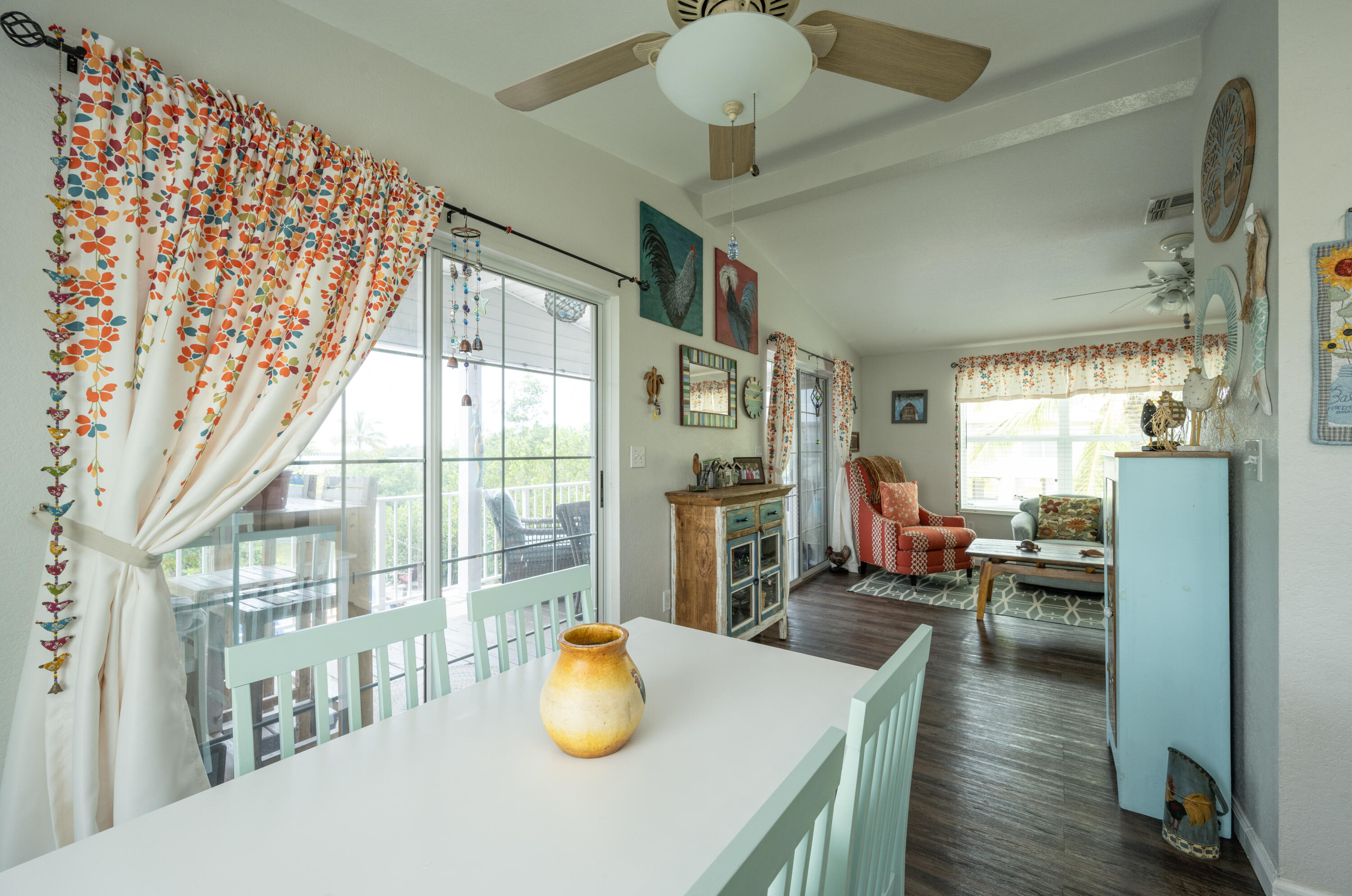 18 West Circle Drive Key West, FL 33040 - Photo 9 of 30 a dining room with wooden floor and a chandelier