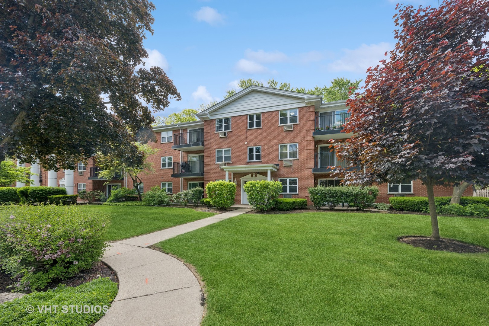 801 East Miner Street, Unit 1A Arlington Heights, IL 60004 - Photo 13 of 21 a view of a big house with a big yard and large trees