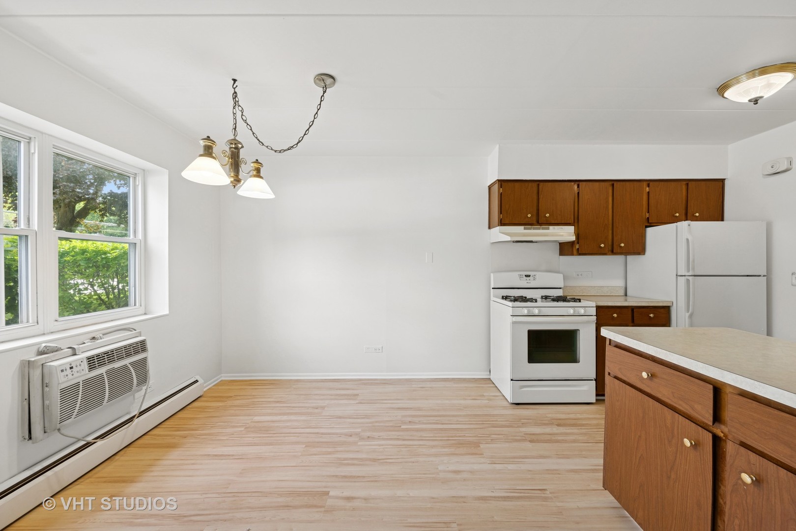 801 East Miner Street, Unit 1A Arlington Heights, IL 60004 - Photo 7 of 21 a kitchen with granite countertop a stove a sink and a microwave