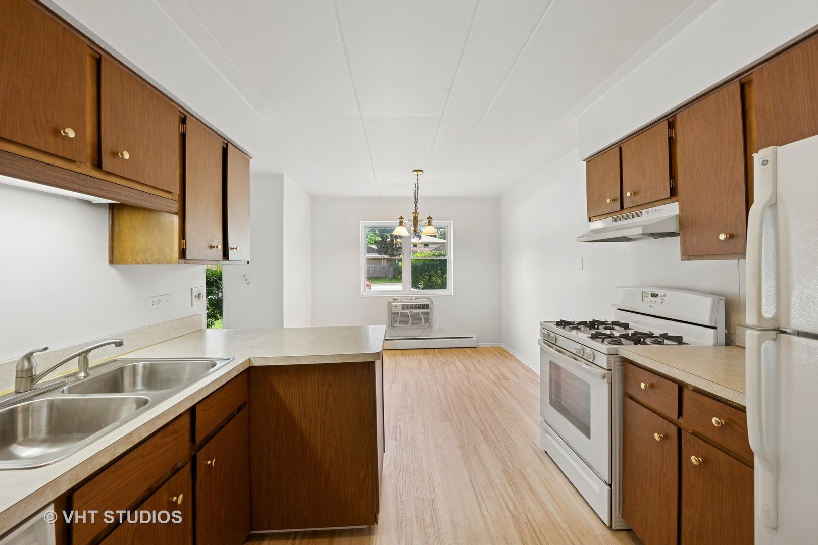 801 East Miner Street, Unit 1A Arlington Heights, IL 60004 - Photo 8 of 21 a kitchen with a sink stove top oven and cabinets
