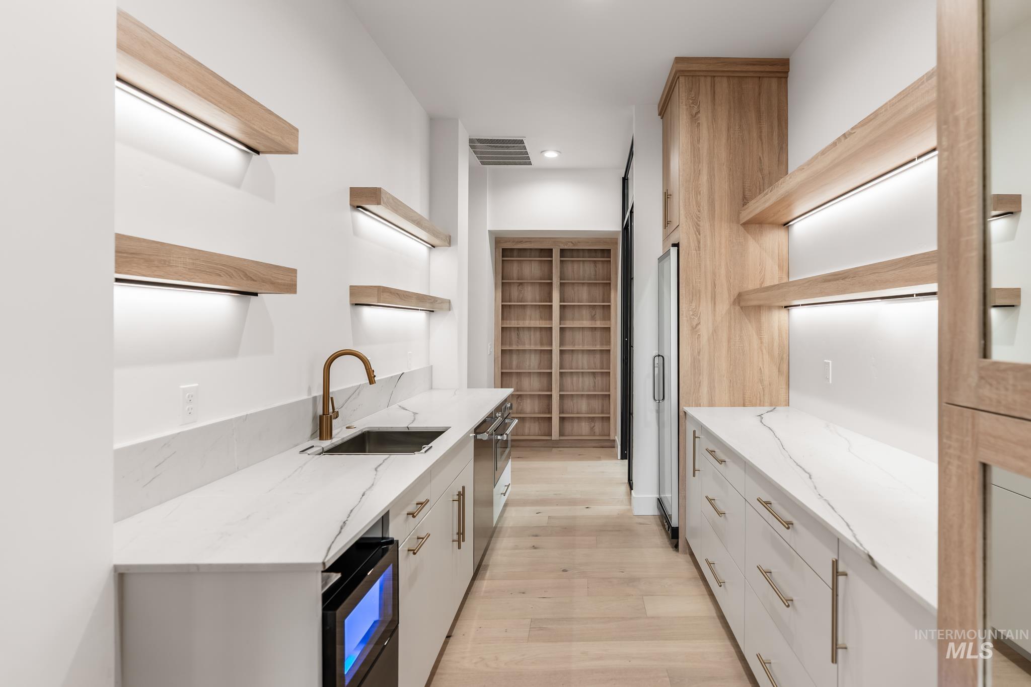 6162 North High Valley Way Boise, ID 83714 - Photo 19 of 50 Kitchen featuring open shelves, light stone counters, light wood-style floors, and recessed lighting