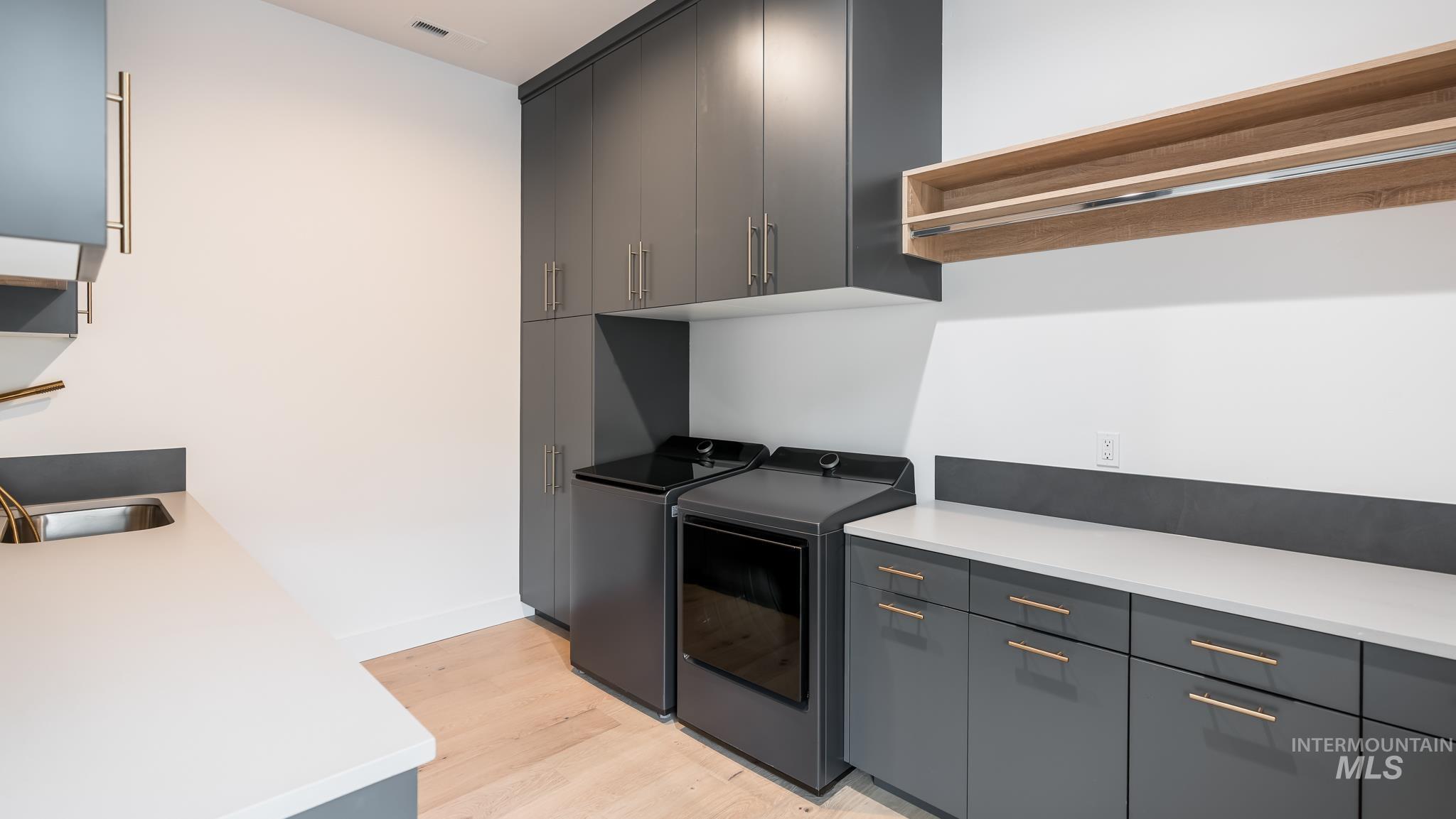 6162 North High Valley Way Boise, ID 83714 - Photo 22 of 50 Laundry room with light wood-type flooring and washer and clothes dryer