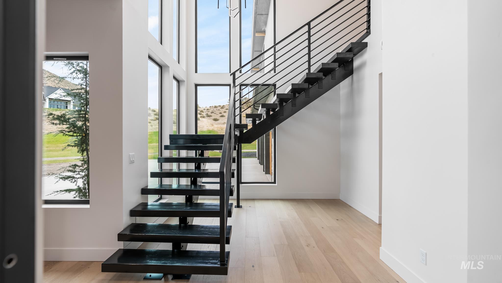 6162 North High Valley Way Boise, ID 83714 - Photo 23 of 50 Stairs with wood finished floors and a high ceiling