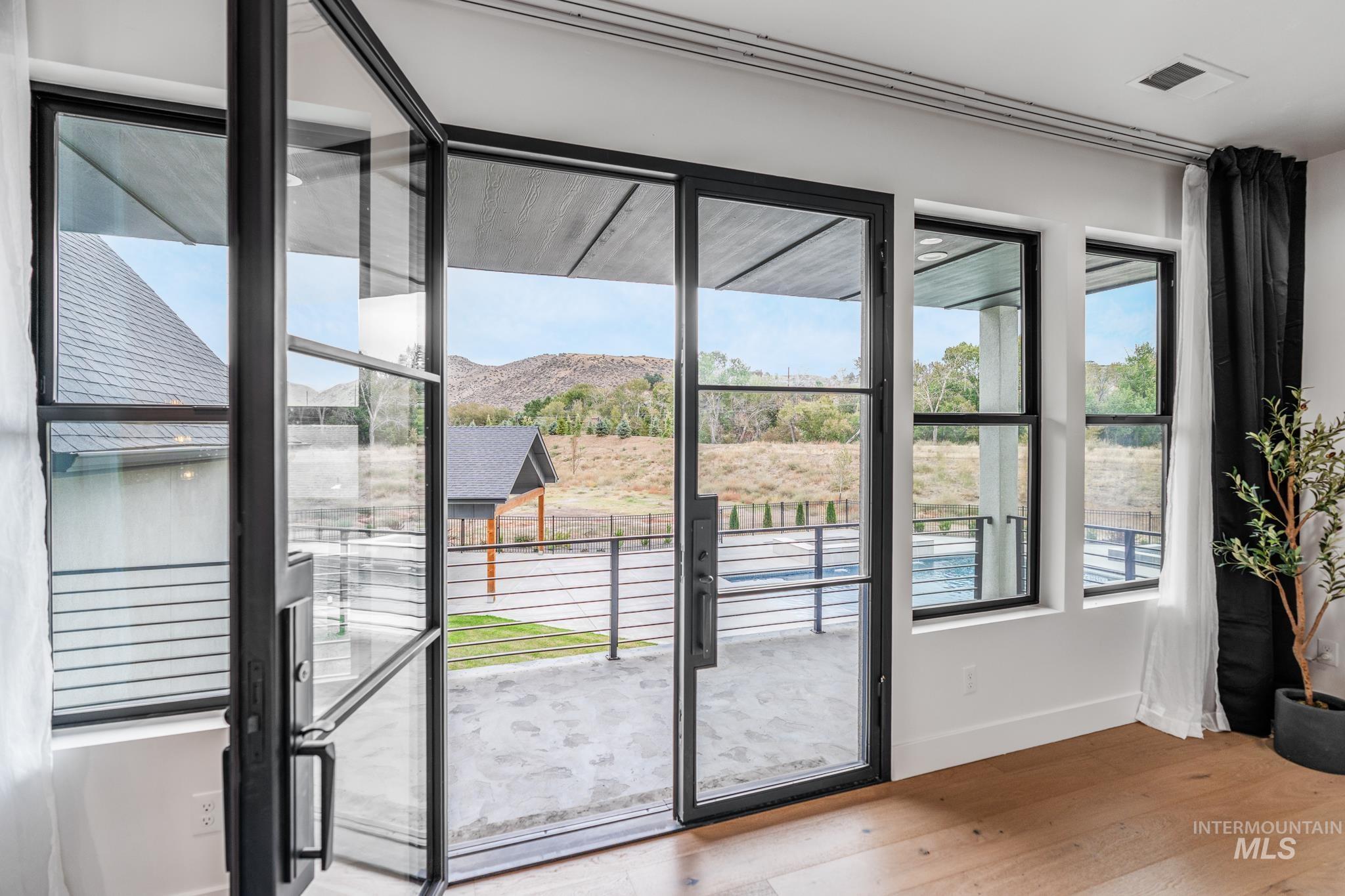 6162 North High Valley Way Boise, ID 83714 - Photo 28 of 50 Doorway with a mountain view and wood finished floors