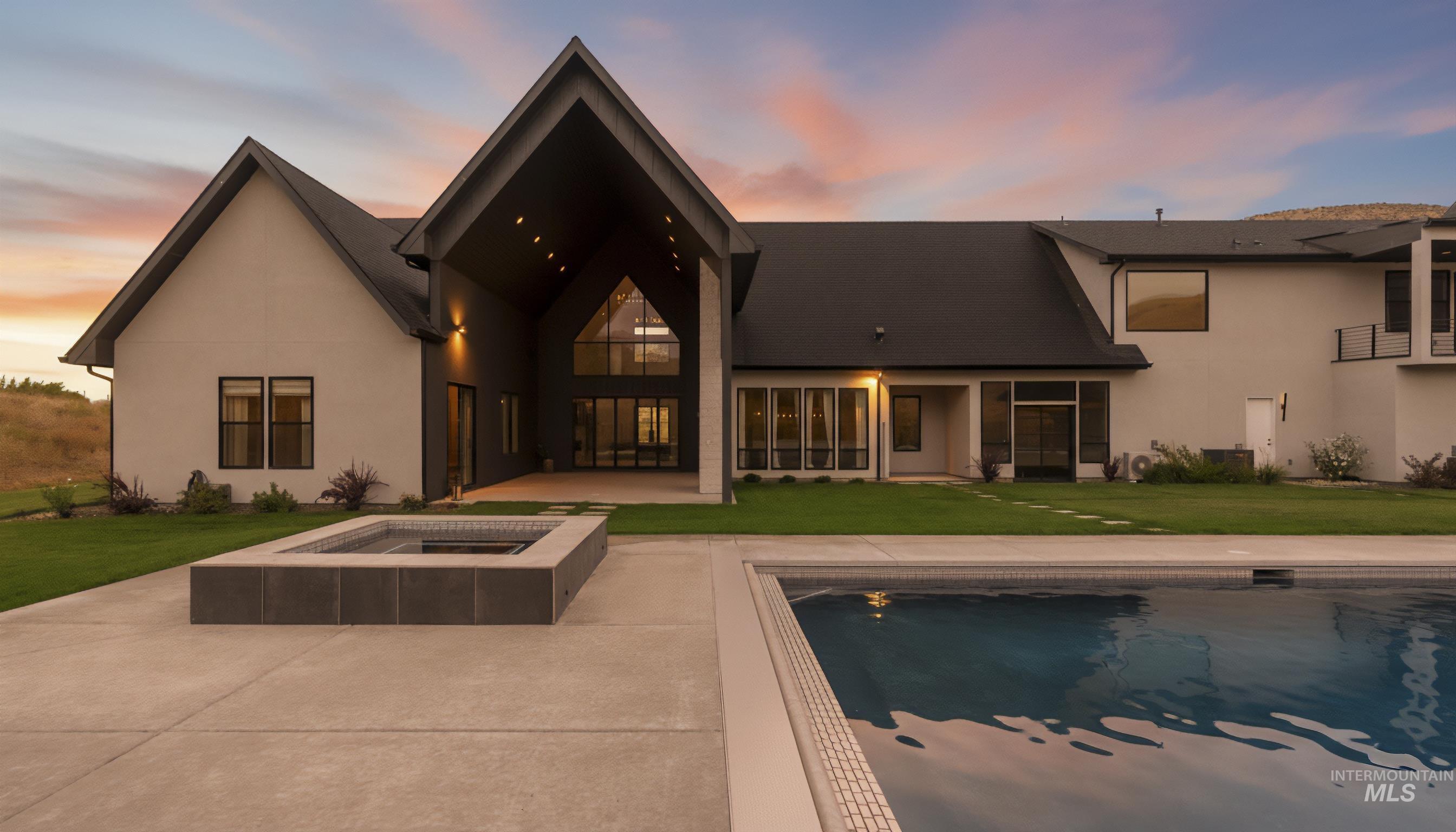 6162 North High Valley Way Boise, ID 83714 - Photo 3 of 50 Rear view of house featuring a lawn, a patio area, an outdoor pool, and stucco siding