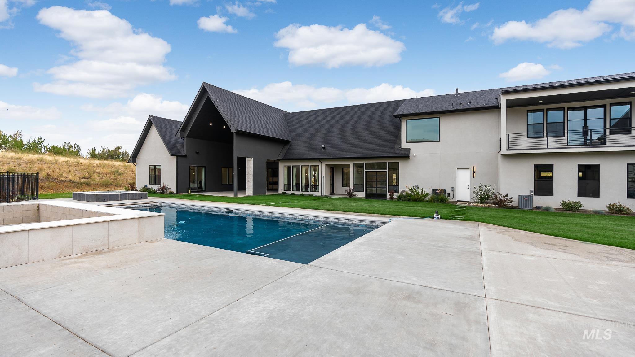 6162 North High Valley Way Boise, ID 83714 - Photo 4 of 50 Swimming pool with an in-ground hot tub, a patio, and a yard