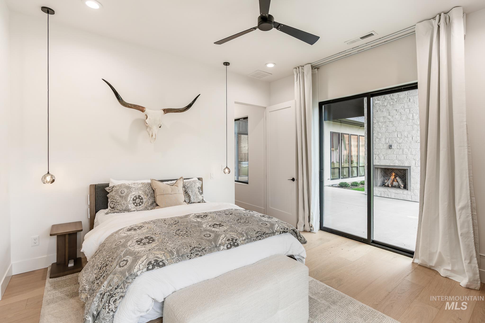 6162 North High Valley Way Boise, ID 83714 - Photo 46 of 50 Bedroom with light wood-style floors, recessed lighting, ceiling fan, access to exterior, and a fireplace