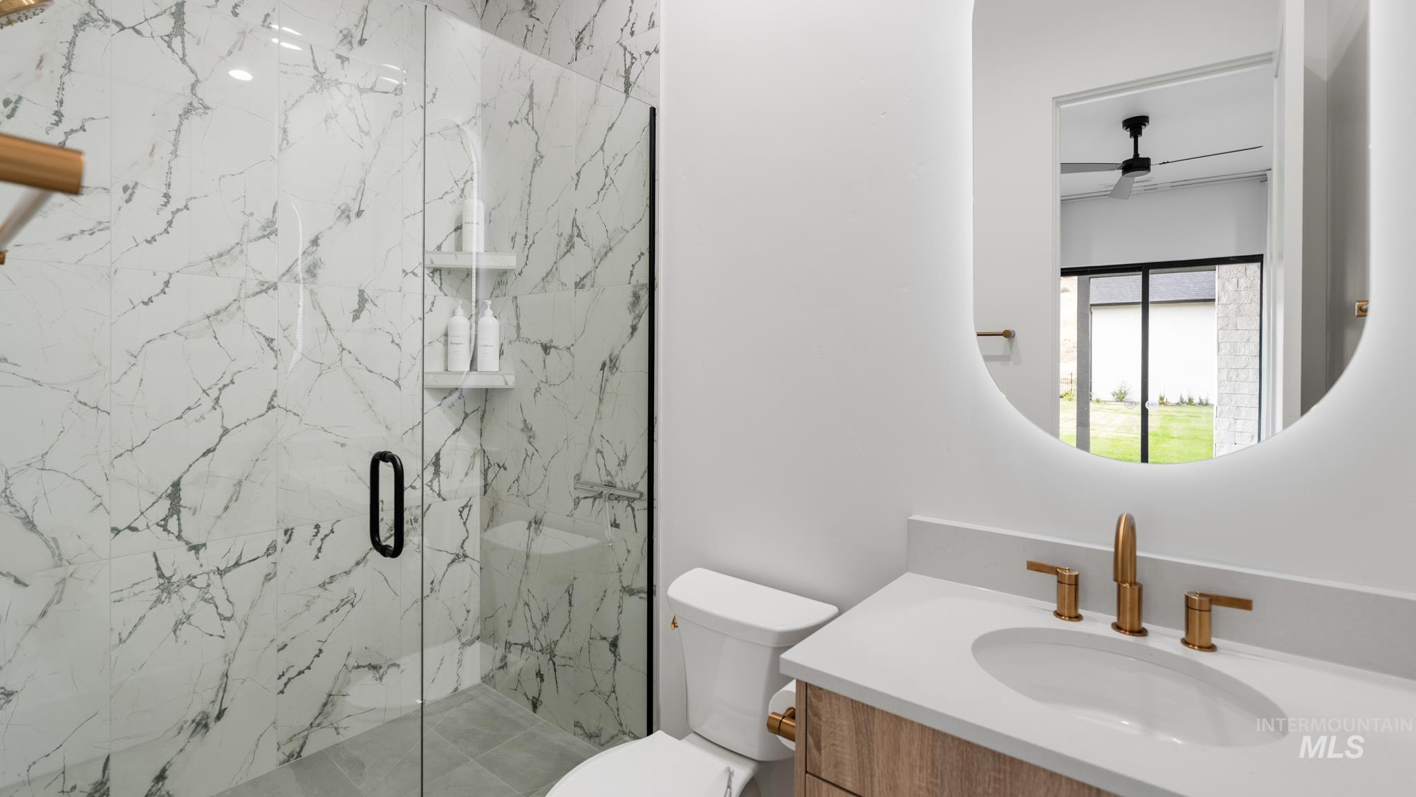 6162 North High Valley Way Boise, ID 83714 - Photo 47 of 50 Full bathroom with vanity, a marble finish shower, and ceiling fan