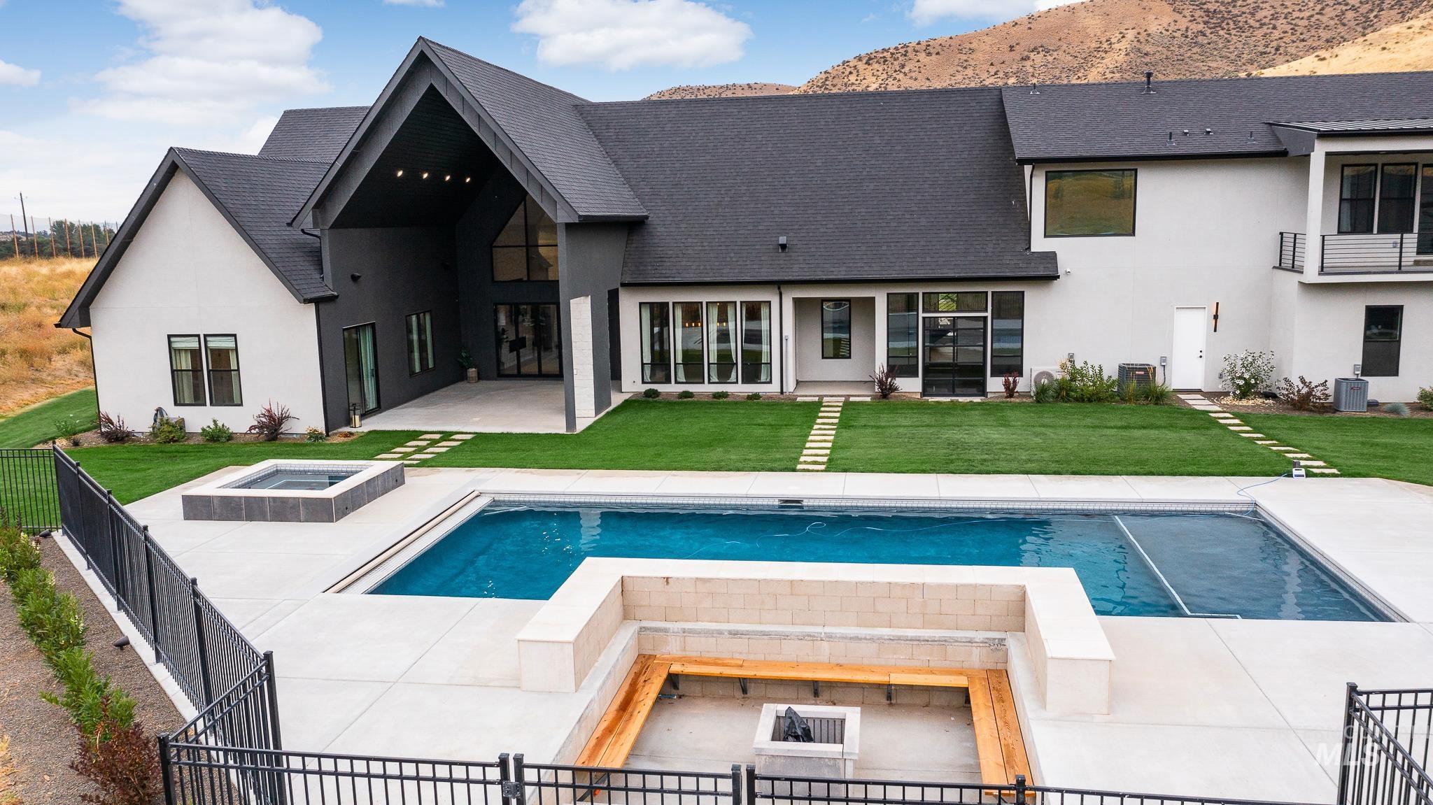 6162 North High Valley Way Boise, ID 83714 - Photo 7 of 50 Back of house featuring a patio, a hot tub, stucco siding, and a shingled roof