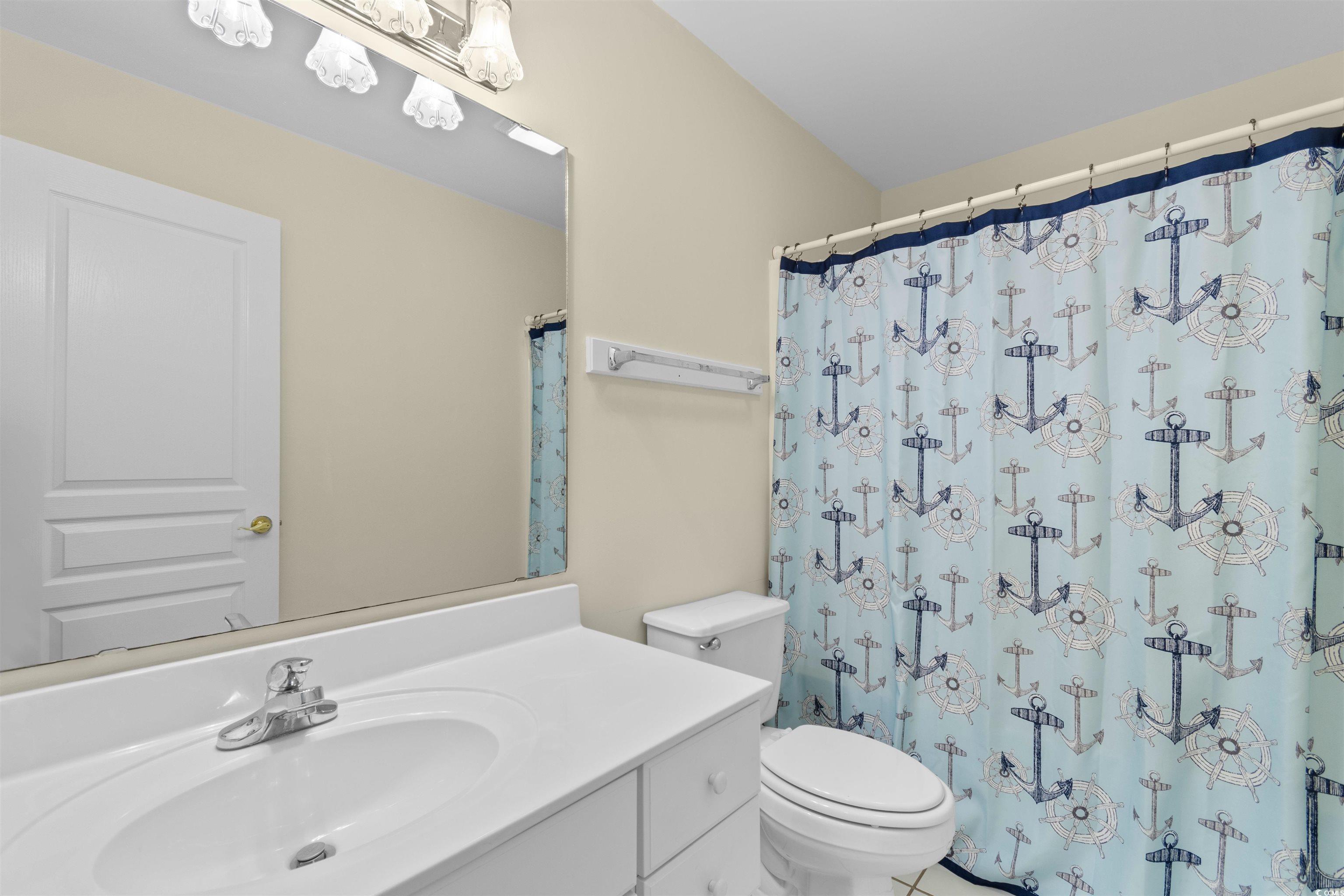 141 Cayman Loop Pawleys Island, SC 29585 - Photo 23 of 40 Full bath with vanity, toilet, and curtained shower