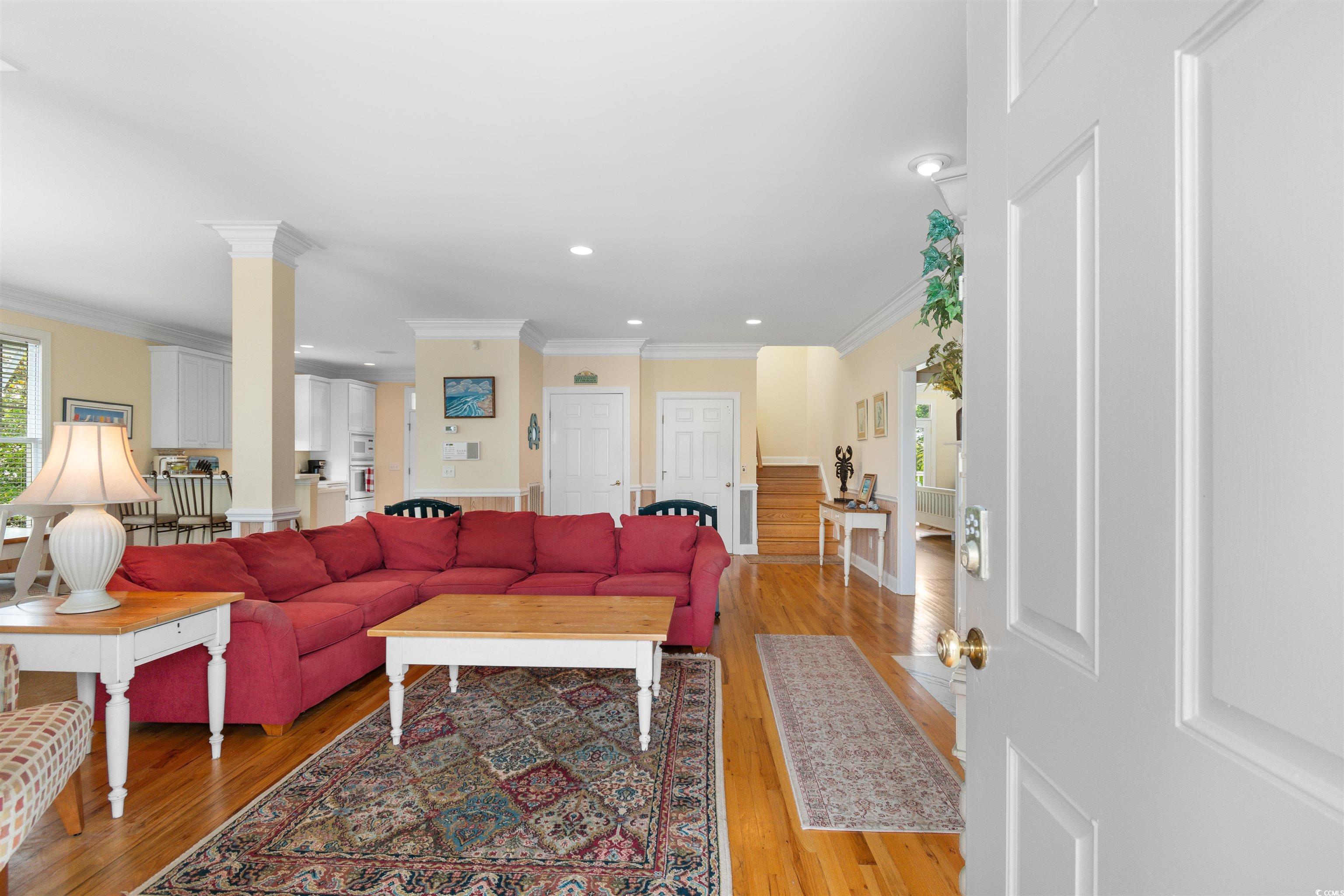 141 Cayman Loop Pawleys Island, SC 29585 - Photo 3 of 40 Living area featuring crown molding, light wood finished floors, ornate columns, and recessed lighting