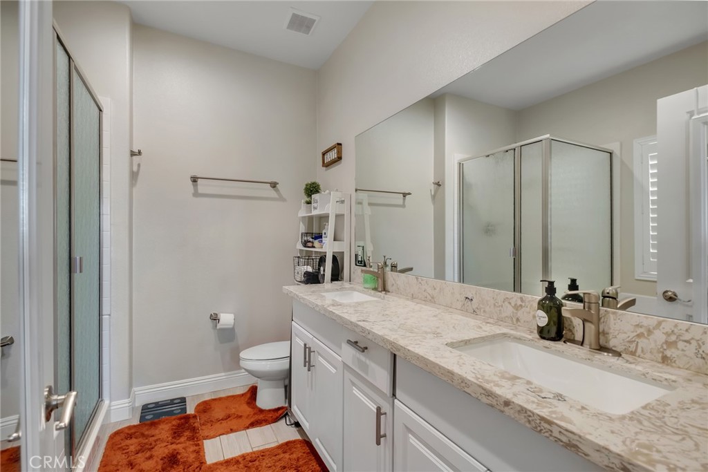 13178 Setancket Road Apple Valley, CA 92308 - Photo 17 of 24 a bathroom with a granite countertop sink and a mirror