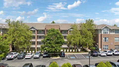 a view of a cars park in front of a building
