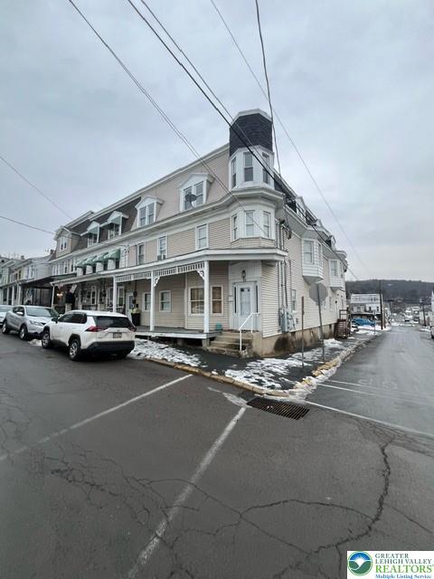 a view of a building with car parked