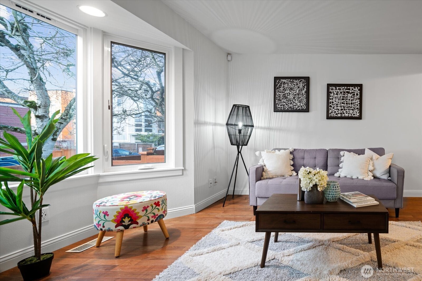 1600 East Yesler Way, Unit 102 Seattle, WA 98122 - Photo 1 of 23 a living room with furniture and a potted plant