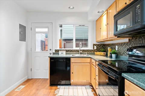 a kitchen with stainless steel appliances granite countertop a stove and a sink