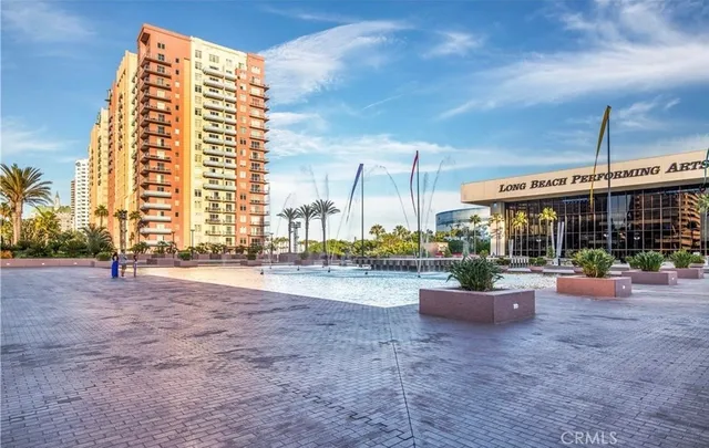 a view of a large building and a couple of cars parked in front of it