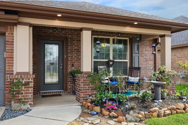 a front view of a house with outdoor seating and a potted plant