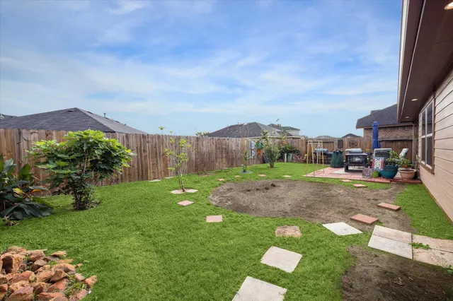 a backyard of a house with table and chairs