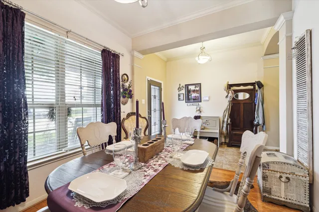 a dining room with furniture and wooden floor