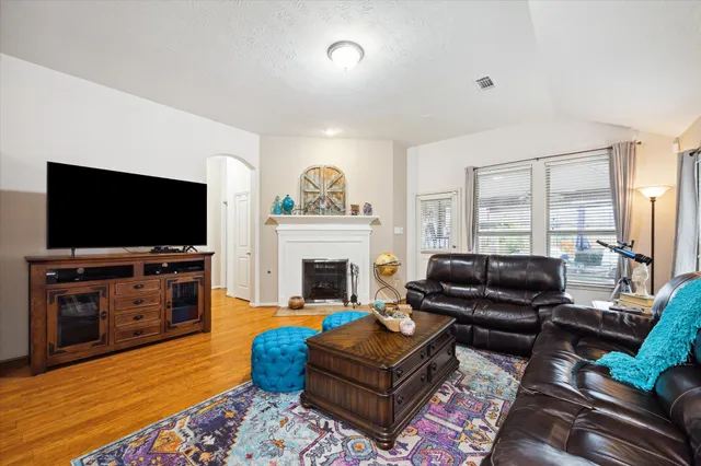 a living room with furniture and a fireplace
