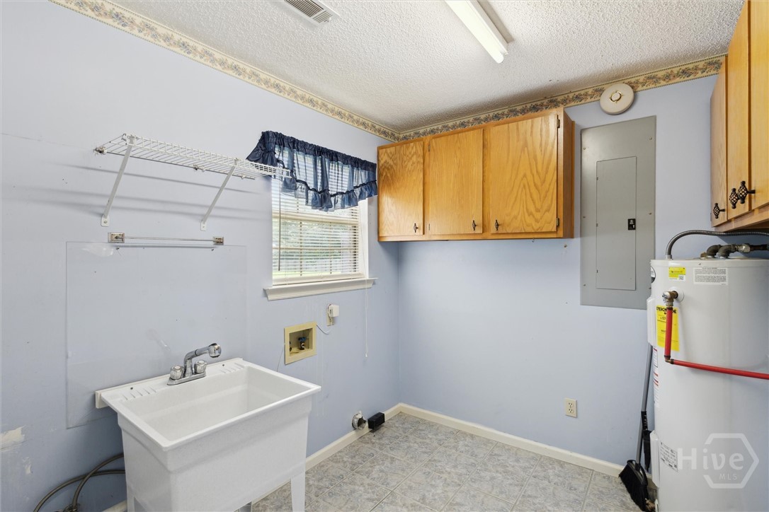500 Archer Road Guyton, GA 31312 - Photo 34 of 50 Full Laundry Room with Deep Sink and Water Heater