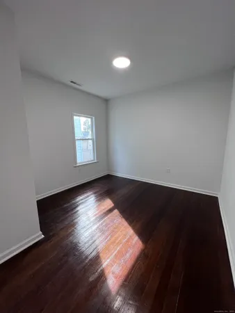 a view of wooden floor and windows in a room