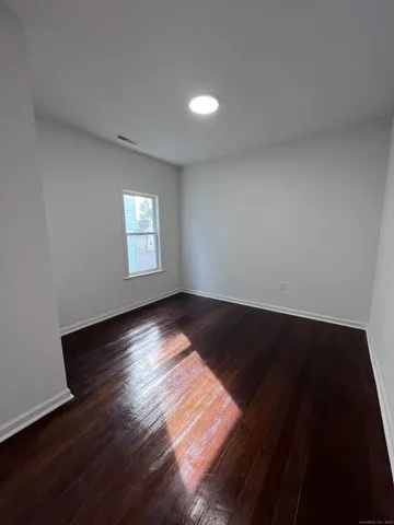 a view of wooden floor and windows in a room