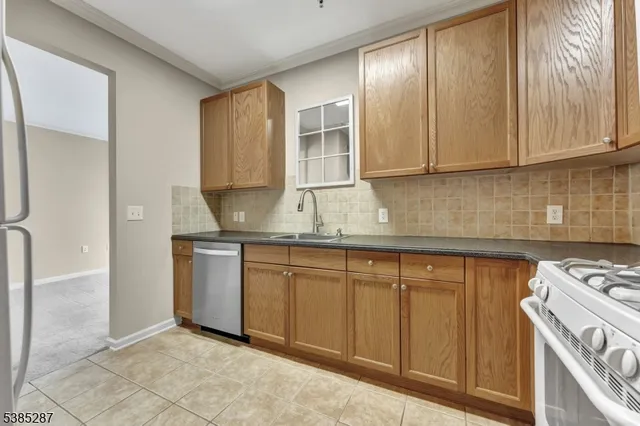 a kitchen with granite countertop cabinets stainless steel appliances and a counter top space