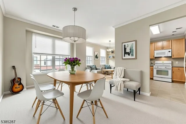a view of a dining room with furniture and chandelier