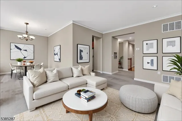 a living room with furniture and a chandelier