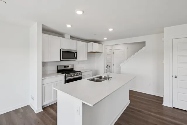a kitchen that has a microwave and a stove