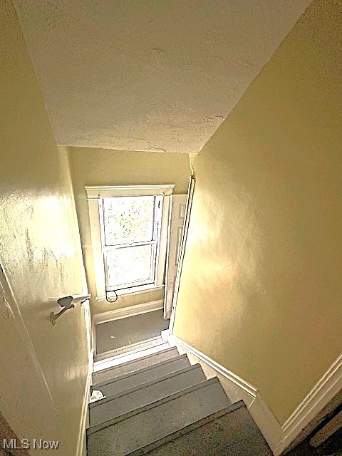 888 Rondel Road Cleveland, OH 44110 - Photo 30 of 35 Stairway with baseboards and a textured ceiling