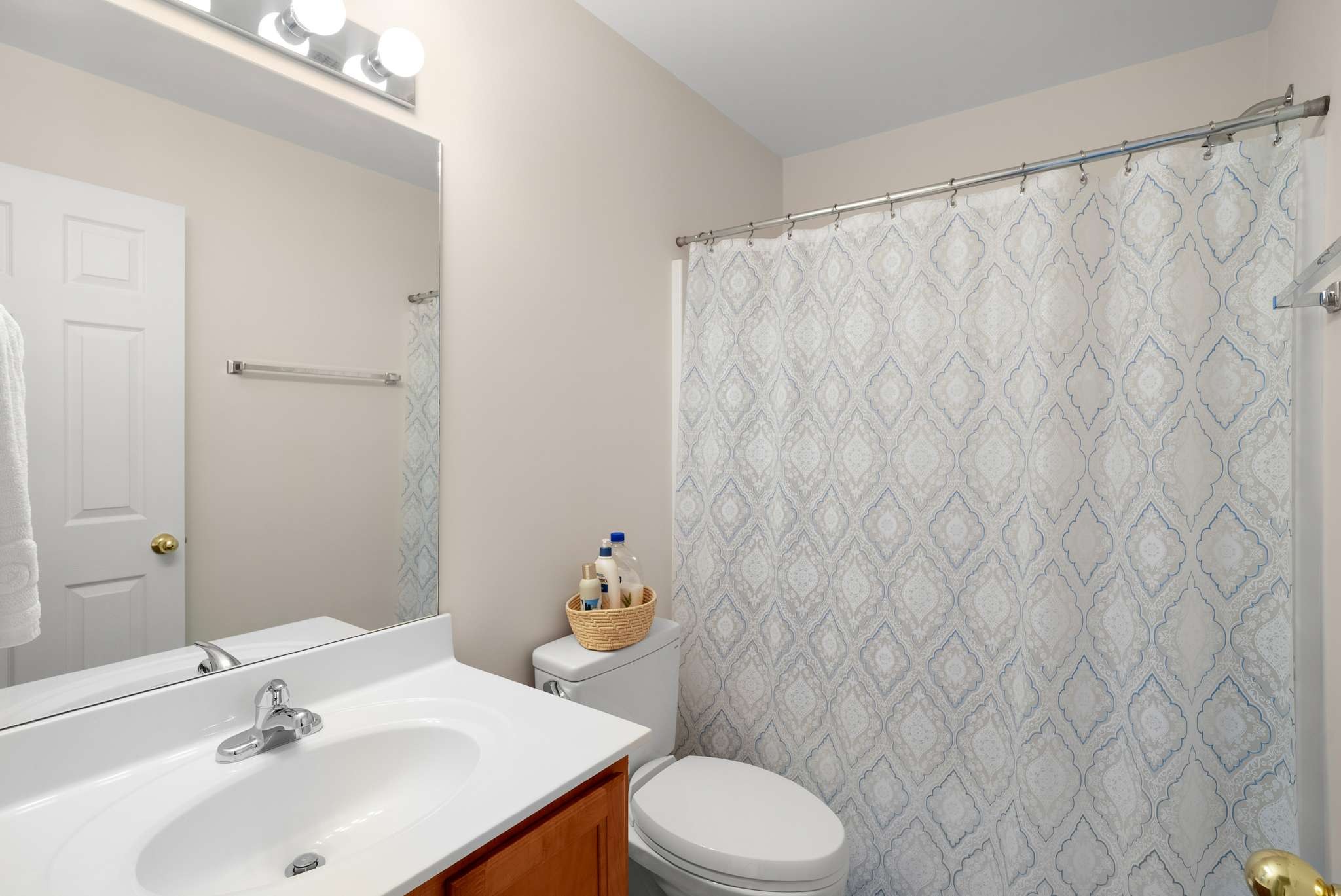 1101 Downs Boulevard, Unit 112 Franklin, TN 37064 - Photo 14 of 35 a bathroom with a sink a toilet and shower curtain
