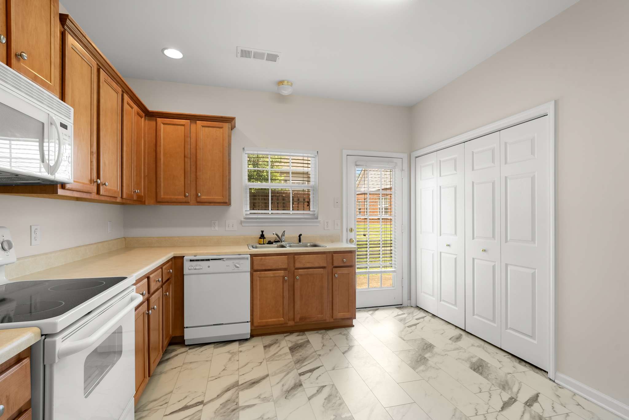 1101 Downs Boulevard, Unit 112 Franklin, TN 37064 - Photo 6 of 35 a kitchen with stainless steel appliances granite countertop a stove a sink dishwasher and a refrigerator