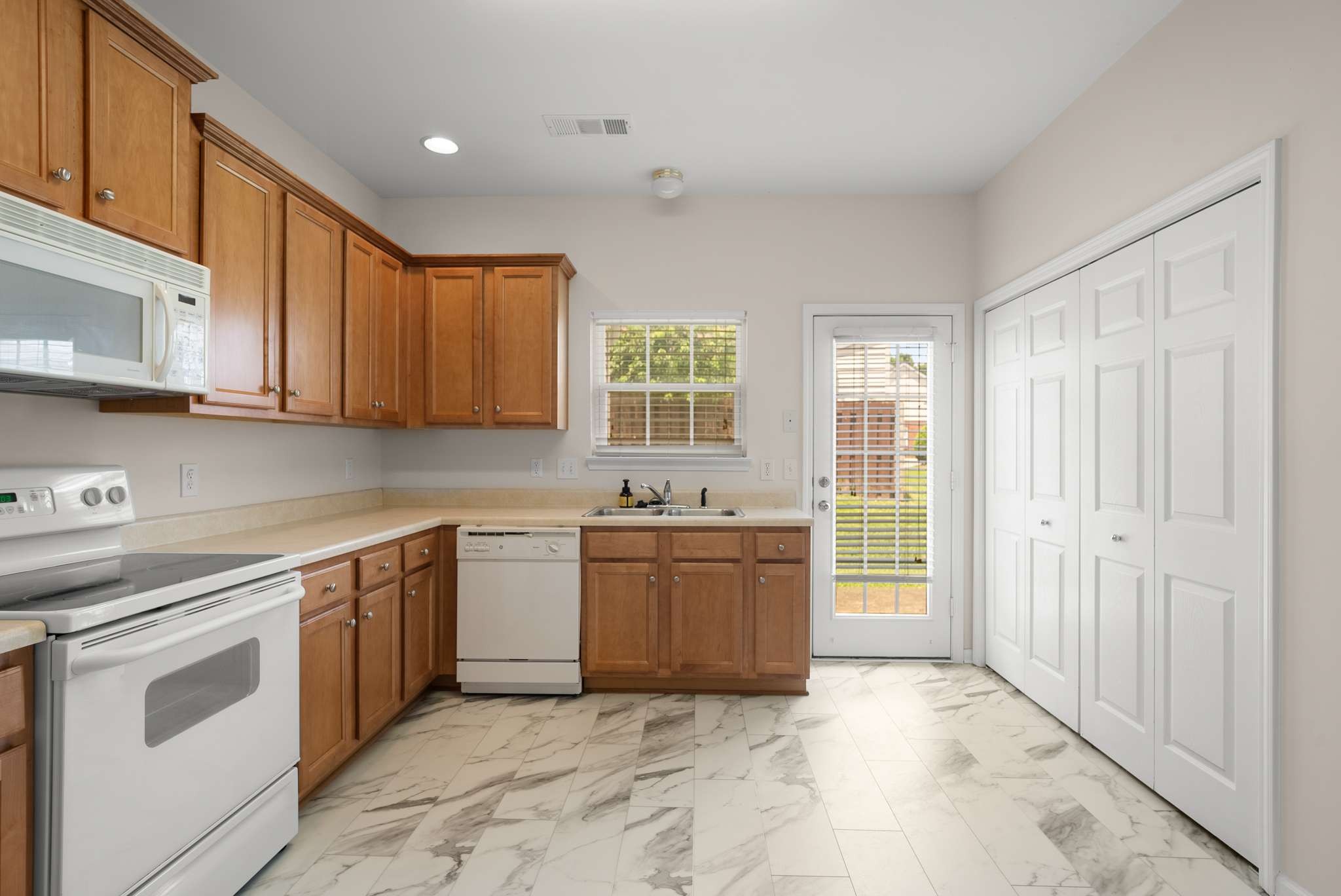 1101 Downs Boulevard, Unit 112 Franklin, TN 37064 - Photo 7 of 35 a kitchen with a stove top oven sink and cabinets