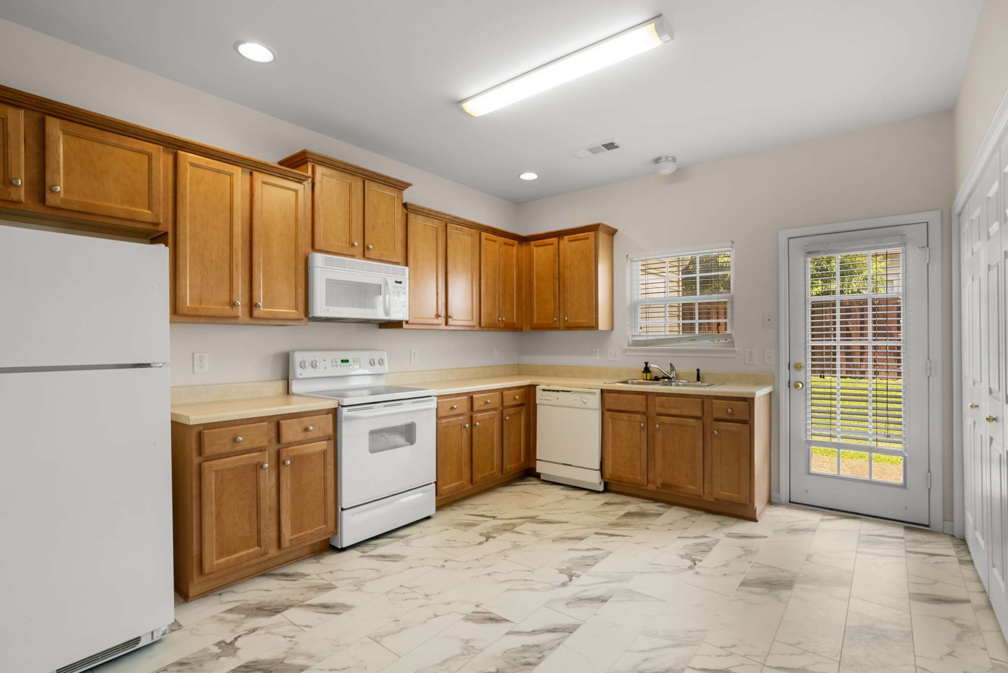 1101 Downs Boulevard, Unit 112 Franklin, TN 37064 - Photo 8 of 35 a large kitchen with stainless steel appliances granite countertop a stove sink and cabinets