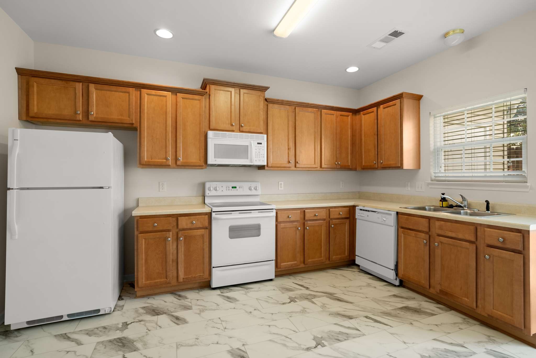 1101 Downs Boulevard, Unit 112 Franklin, TN 37064 - Photo 9 of 35 a kitchen with stainless steel appliances granite countertop a refrigerator sink and stove