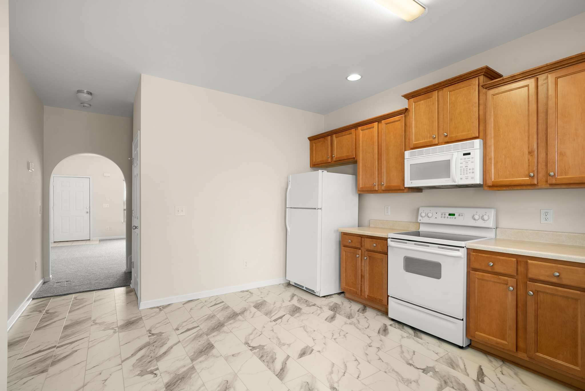1101 Downs Boulevard, Unit 112 Franklin, TN 37064 - Photo 10 of 35 a kitchen with stainless steel appliances granite countertop a stove a sink and a microwave