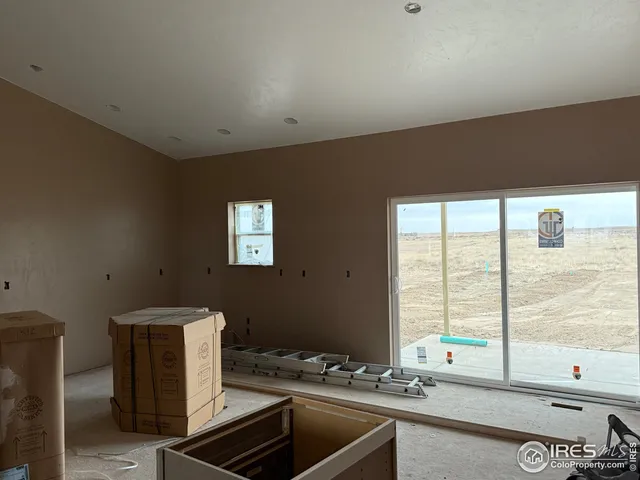 a kitchen with a sink and large windows