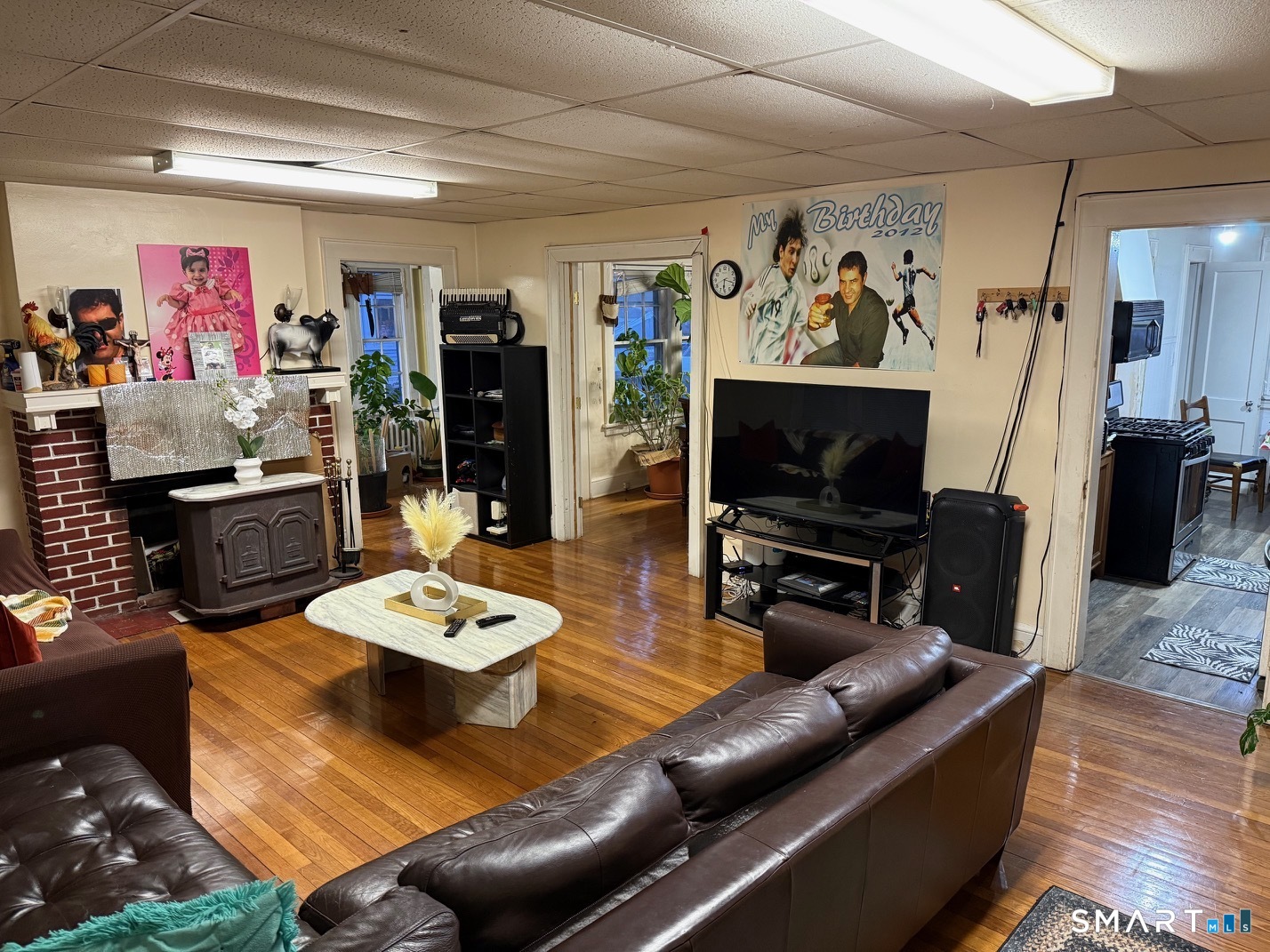 3461 East Main Street Bridgeport, CT 06606 - Photo 11 of 40 a living room with furniture and a flat screen tv