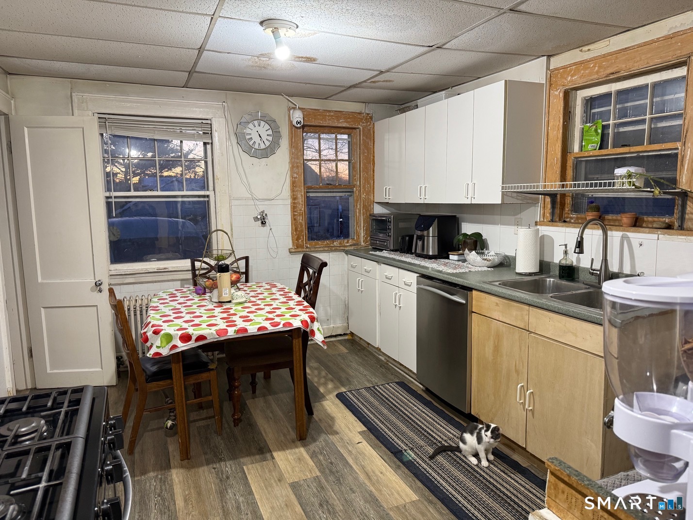 3461 East Main Street Bridgeport, CT 06606 - Photo 17 of 40 a kitchen with a table chairs stove and cabinets