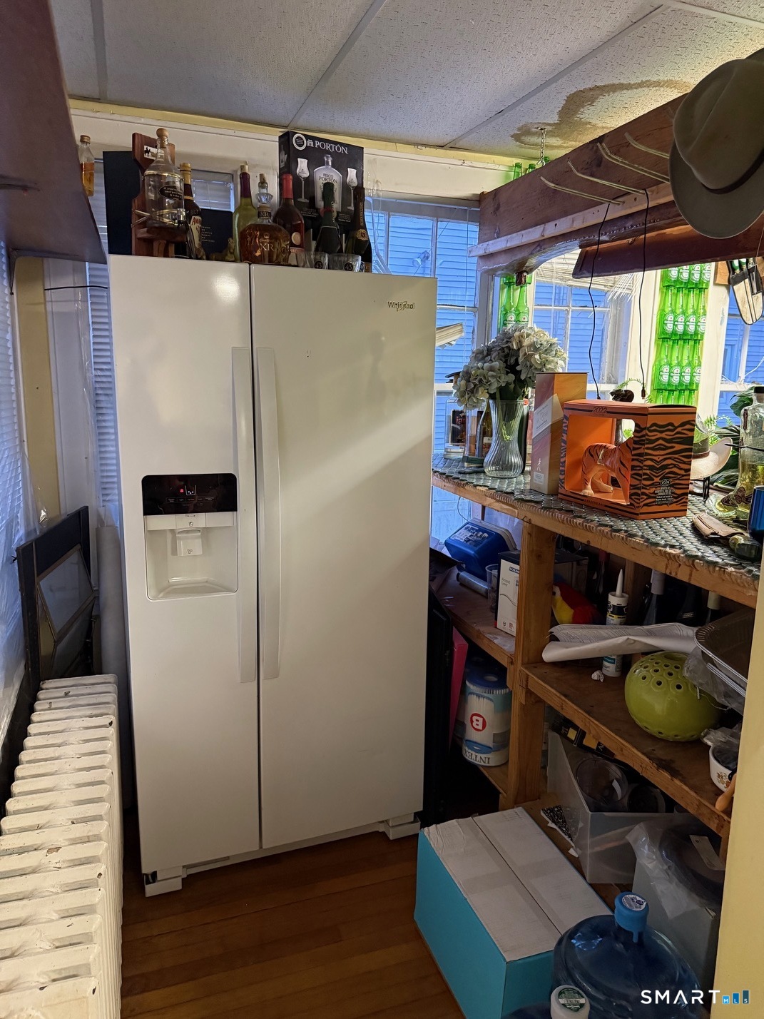 3461 East Main Street Bridgeport, CT 06606 - Photo 21 of 40 a kitchen with stainless steel appliances a stove a refrigerator a sink a dining table and chairs with wooden floor